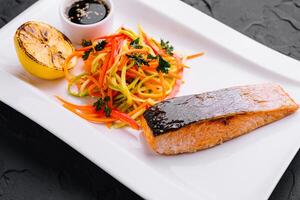 grilled salmon fillet steak with vegetable salad photo