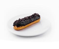 delicious chocolate French eclair on plate photo