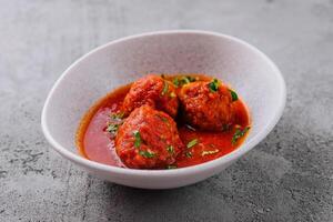 Meatballs with tomato sauce and parsley photo