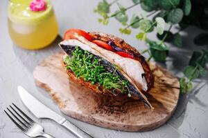 Mackerel fish sandwich on wooden board photo