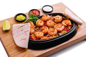 Shrimp fajitas with bell pepper and onion photo