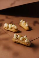eclairs with whipped cream and hazelnuts photo
