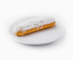 eclair in white glaze and coconut flakes photo