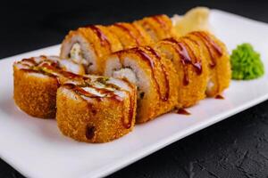 Warm tempura sushi rolls close up photo