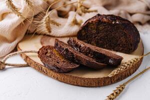 Black round bread on a cutting board photo