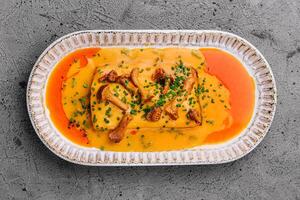 lasagna with chanterelle mushrooms in yellow sauce photo