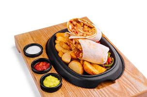 shawarma with fried potato wedges and different sauce photo