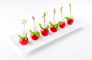 mozzarella with cherry tomatoes on a skewer photo