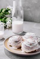 Tasty homemade vanilla cupcakes and bottle of milk photo