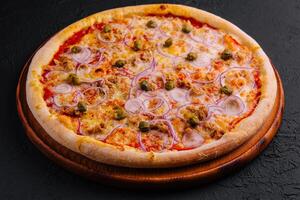 Delicious pizza Tuna with tomatoes, olives, onion and capers photo