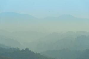 Abstract nature background of complex mountains. Lined up in the distance and disappeared into the mist. photo