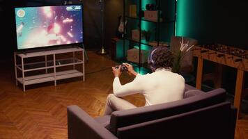 Gamer receiving game over screen on ultrawide smart TV, losing all health, failing to win level and beat enemies. BIPOC player defeated in science fiction singleplayer videogame, panning shot video