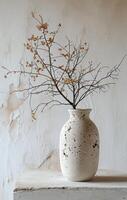 AI generated a vase with dried branches is sitting on a white table photo