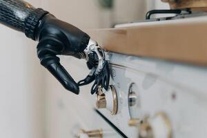 Prosthetic robotic arm in action, skillfully adjusting kitchen appliance settings, merging daily life with advanced tech photo