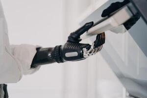 Precision and technology converge as a bionic hand operates a control panel, symbolizing the new era of human-machine integration photo