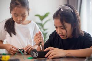 nventive kids learn at home by coding robot cars and electronic board cables in STEM. constructing robot cars at home photo