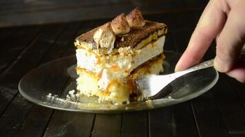 cutting a piece of truffle cake with a fork on a dark background. video