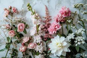 ai generado rosa, blanco y blanco flores arreglado en un blanco hormigón antecedentes foto