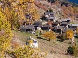 a mountain with a few houses on it photo