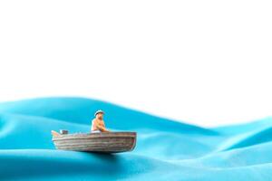 Fisherman in a boat on the waves,  World Water Day concept photo