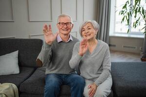 Happy senior woman man talk on video call with friends family. Mature old grandmother grandfather talking speaking with grown up children online. Older generation modern tech usage. Webcamera view photo