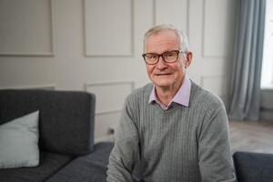 Portrait of confident stylish European middle aged senior man at home. Older mature 70s man smiling. Happy attractive senior grandfather looking camera close up face headshot portrait. Happy people photo