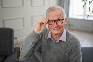 Portrait of confident stylish European middle aged senior man at home. Older mature 70s man smiling. Happy attractive senior grandfather looking camera close up face headshot portrait. Happy people photo