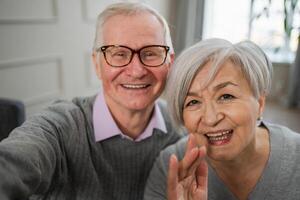 Happy senior woman man talk on video call with friends family. Mature old grandmother grandfather talking speaking with grown up children online. Older generation modern tech usage. Webcamera view photo