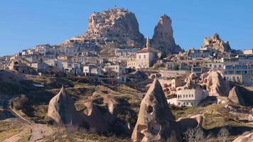 View of Uchisar Castle in Cappadocia, Turkey and the surrounding city with several old troglodyte settlements in the foreground. video