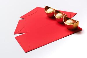 Chinese New Year Spring festival decorations red packet and gold ingots on white background. photo