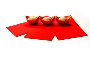 Chinese New Year Spring festival decorations red packet and gold ingots on white background. photo