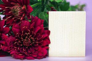 Wooden cube with flower bouquet. photo