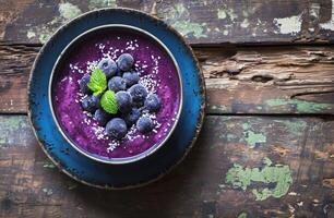 AI generated bowl of berry smoothie on rustic wooden table photo