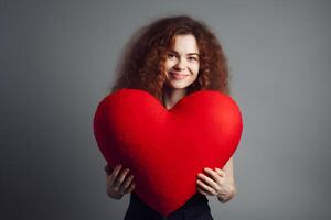 AI generated woman holding big red heart on gray background, neural network generated photorealistic image photo