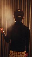 Silhouette of a person against a curtain with backlighting creating a mysterious atmosphere. video