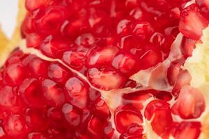 Fresh ripe pomegranate isolated on white background. close up of juicy pomegranate cut in half. Ripe fruit is a healthy food. photo