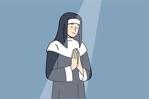 Nun prays to god with palms folded in front chest, standing under beam light in cathedral building vector