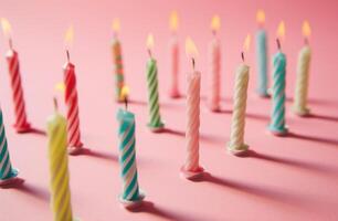 ai generado cumpleaños de colores velas arreglado en un rosado antecedentes foto