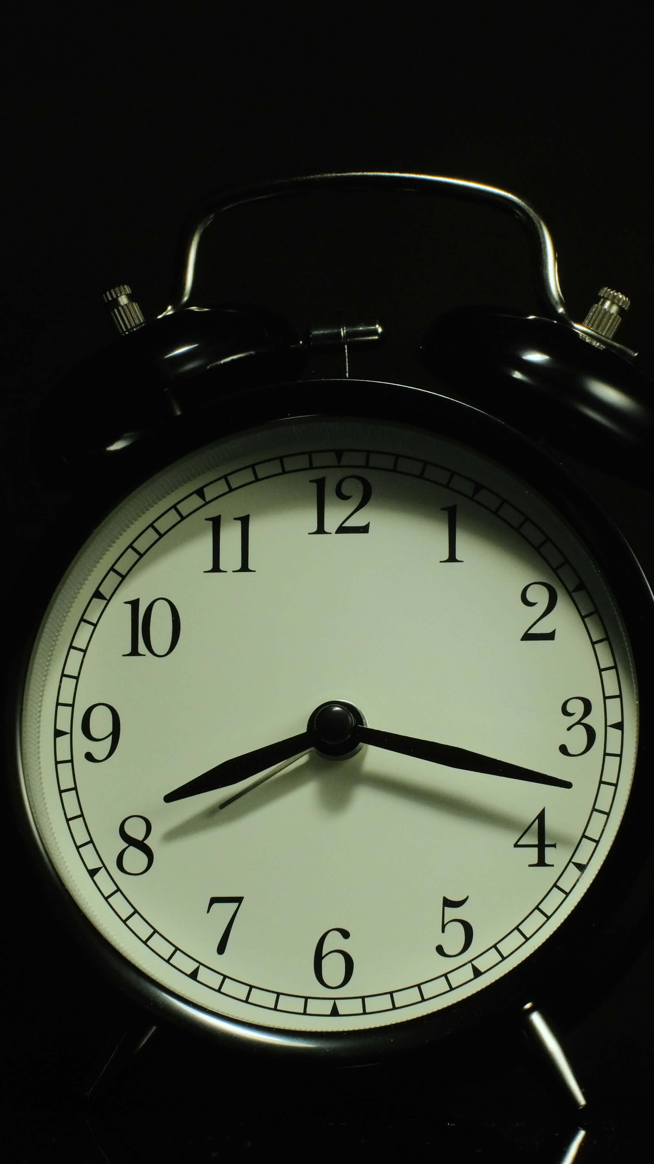 Vertical time lapse video of a clock time passing over a day to night
