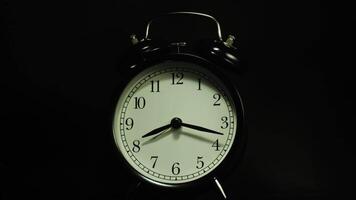 The alarm clock on a black background, in the style of time-lapse video. video