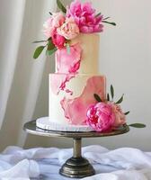 AI generated white and pink cake on a metal stand with pink flowers photo