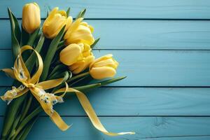 AI generated yellow tulips with blue gift box on blue wooden background photo