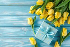 AI generated yellow tulips with blue gift box on blue wooden background photo