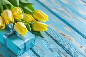 AI generated yellow tulips with blue gift box on blue wooden background photo