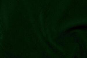 Green velvet fabric texture used as background. Emerald color panne fabric background of soft and smooth textile material. crushed velvet .luxury emerald tone for silk... photo