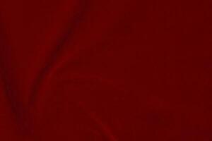 Dark red velvet fabric texture used as background. silk color scarlet fabric background of soft and smooth textile material. crushed velvet .luxury dark tone for silk. photo