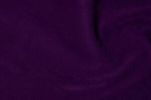 Dark purple velvet fabric texture used as background. violet color purple fabric background of soft and smooth textile material. crushed velvet .luxury dark tone for silk. photo