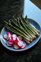 AI generated a plate of asparagus, a bottle of dressing, and skewers photo