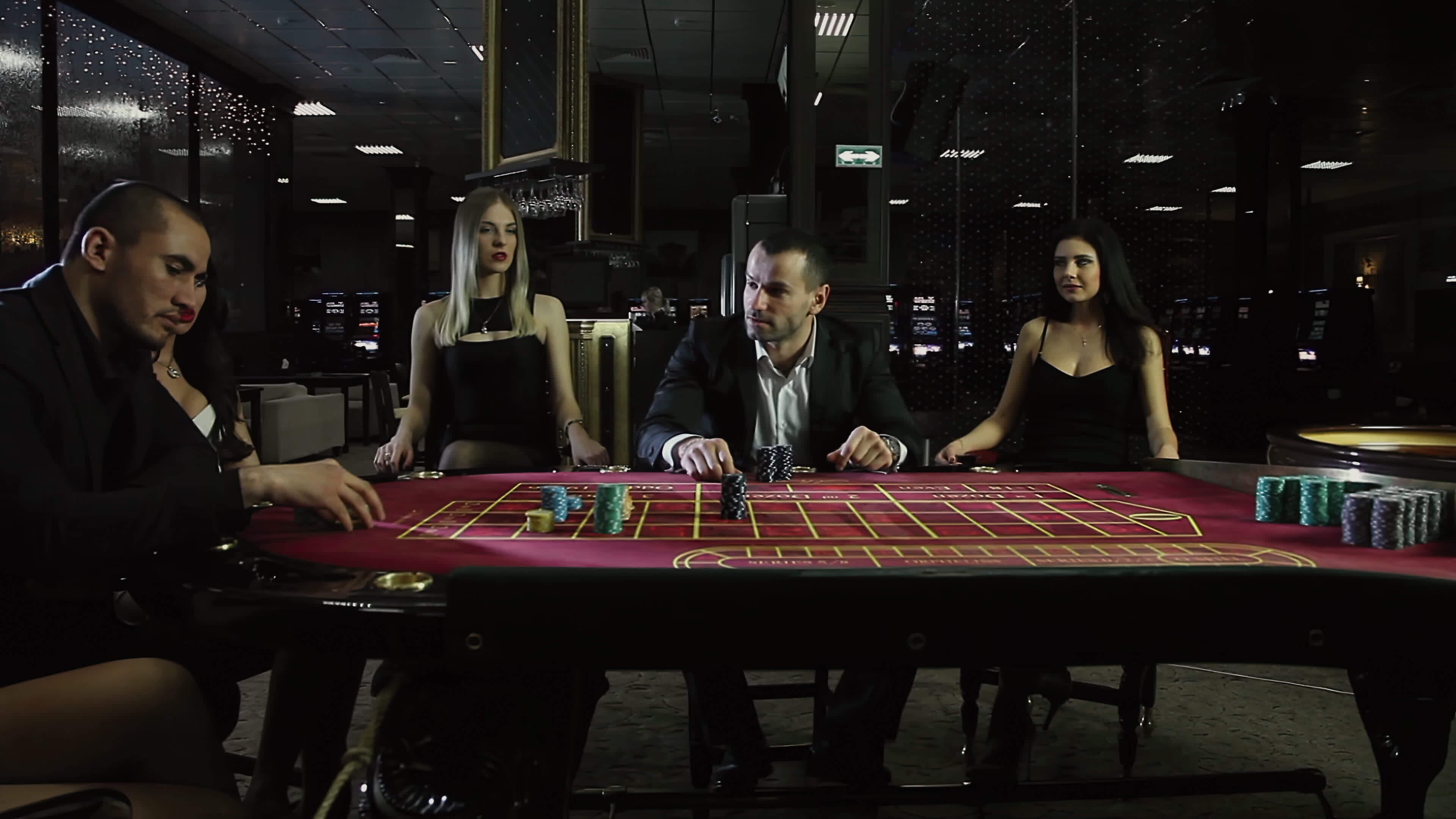 Two brutal men play at the Casino, surrounded by girls 37336510 Stock ...