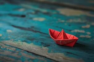 ai generado un pequeño papel barco con rojo vela en de madera cubierta foto